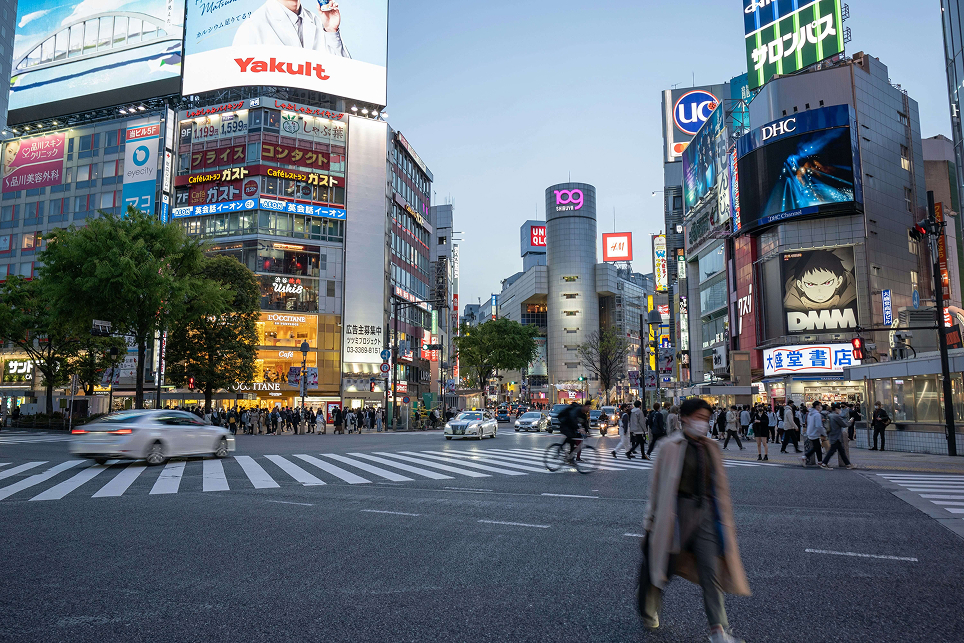 Bustling Tokyo street intersection at dusk